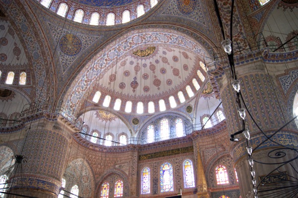 Looking up into the domes inside the Blue Mosque, covered in colourful decorative patterns.