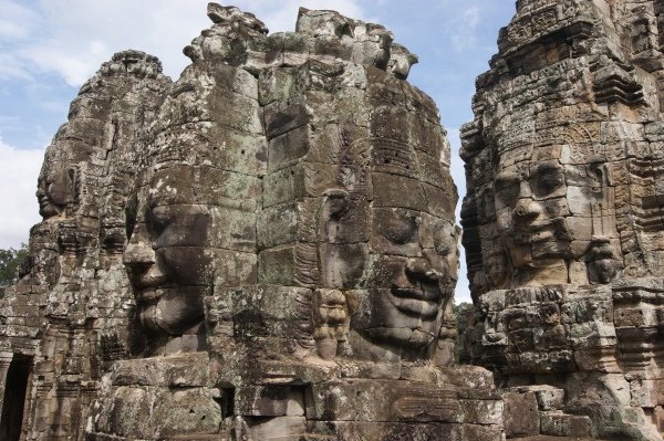 Closer view of several towers at Bayon, showing smiling faces looking out in all directions