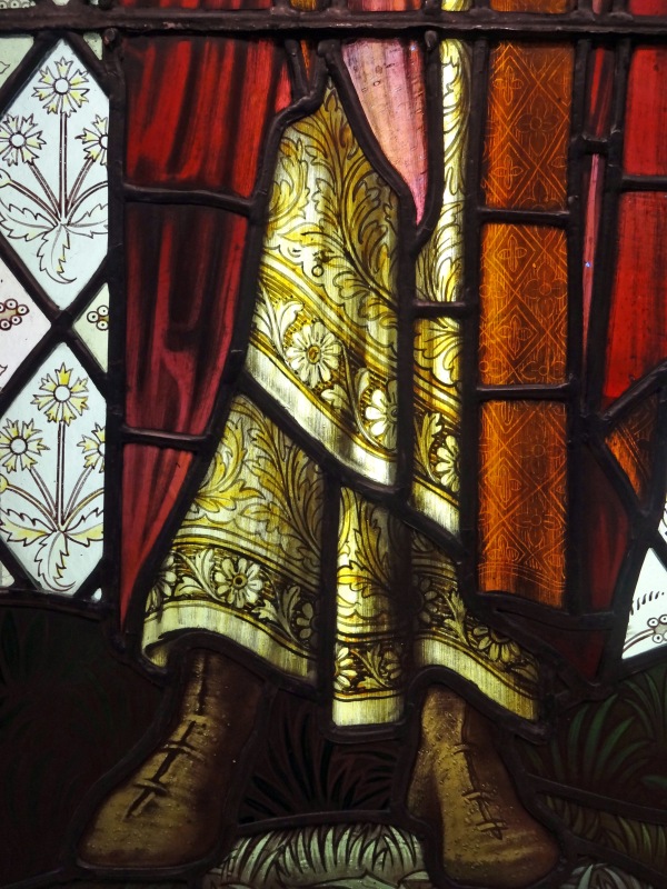 Detail of Stained glass window, St Paul's feet and patterned fabrics