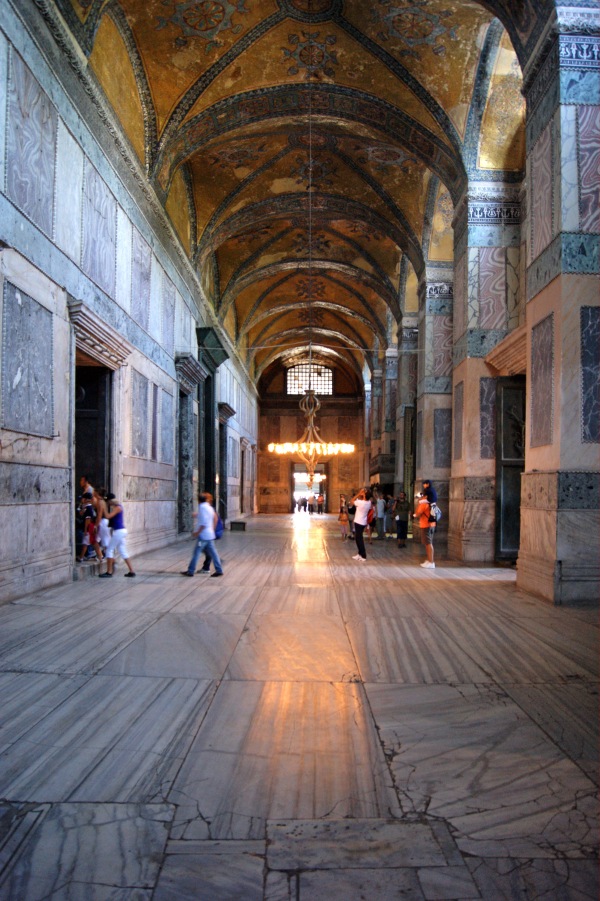 In the arcades that surround the massive central prayer space of the great dome Basilica of Hagia Sophia, the walls and pillars are all clade in thin slices of variegated stone.